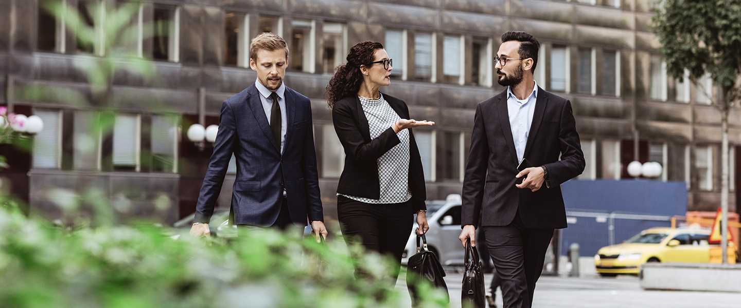 business-people-walking-in-green-business-yard