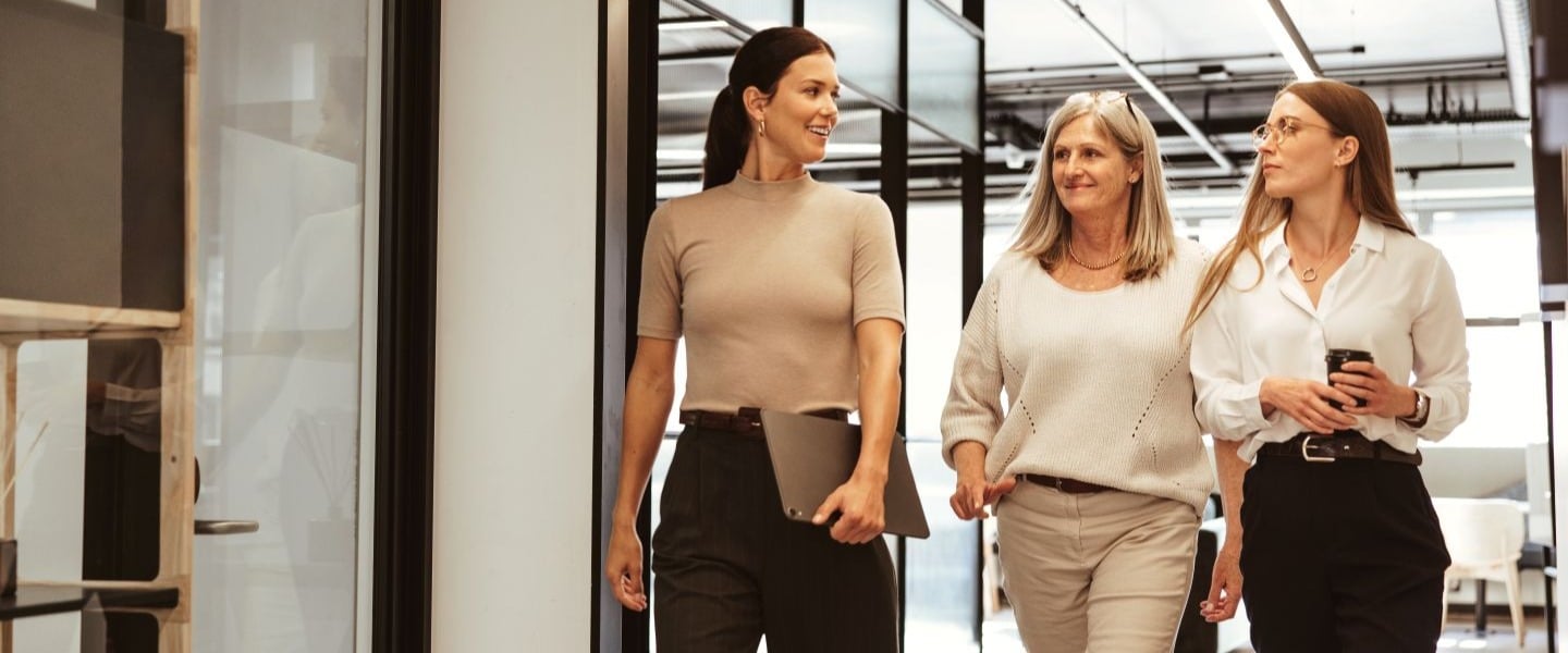 three women walking in office